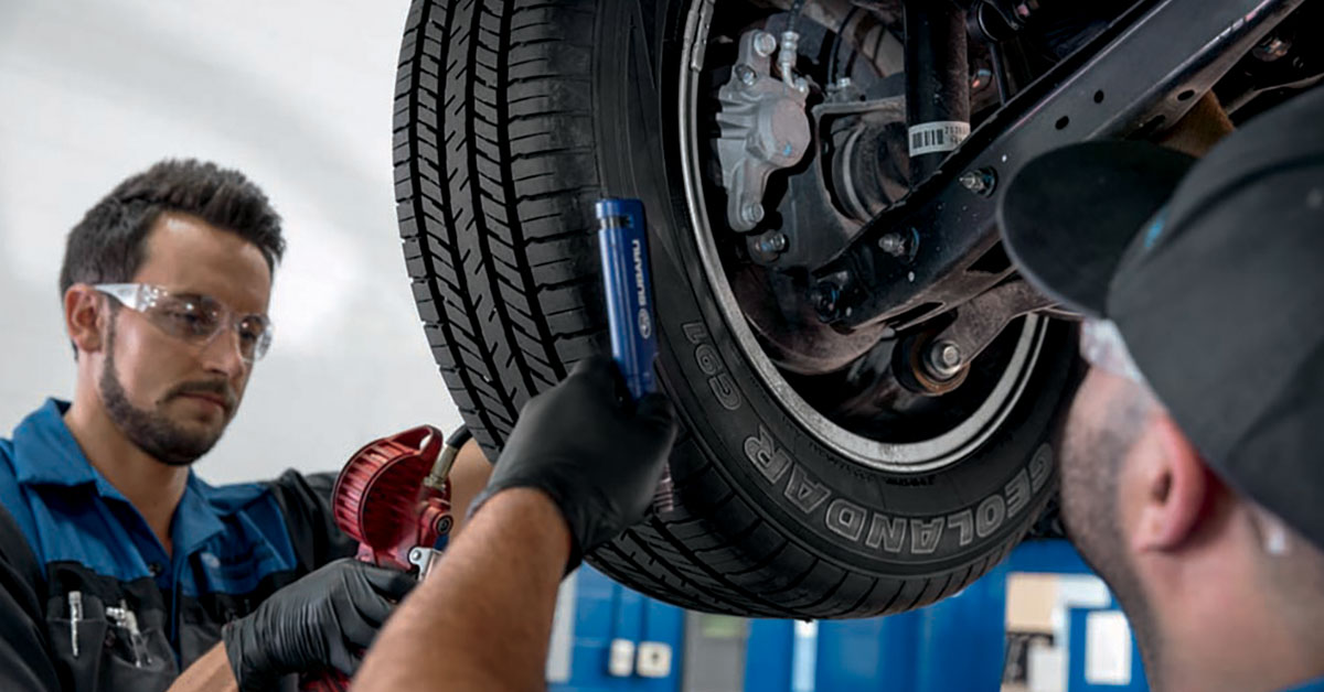 Subaru tire service technicians working on a vehicle