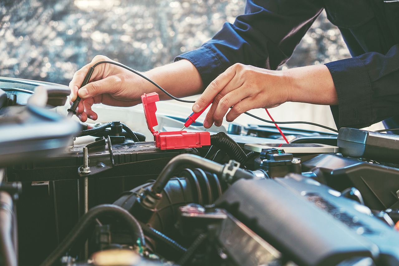 Subaru service technician testing a battery