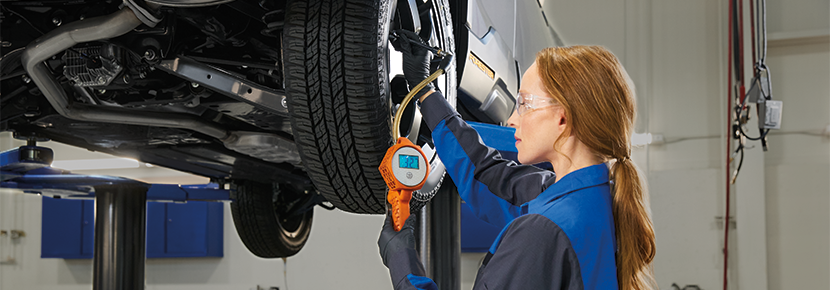 A Subaru technician checking tire pressure. | Mid-Hudson Subaru in Wappingers Falls NY