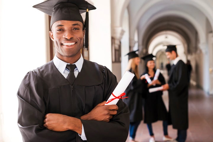 college graduate holding his diploma | Mid-Hudson Subaru in Wappingers Falls NY
