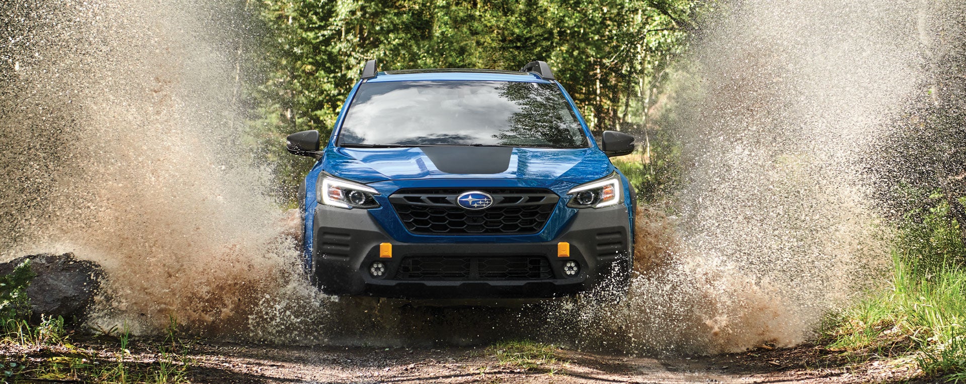 A 2023 Outback Wilderness driving on a muddy trail. | Mid-Hudson Subaru in Wappingers Falls NY
